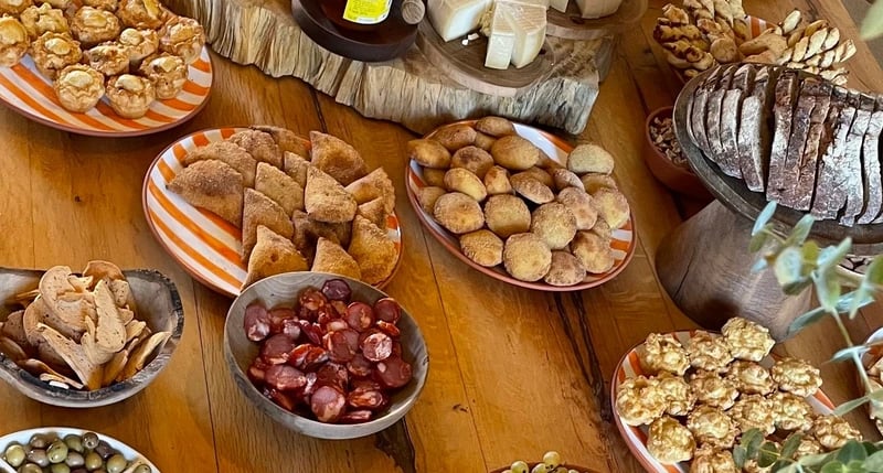 Table spread with cheese, bread and olives