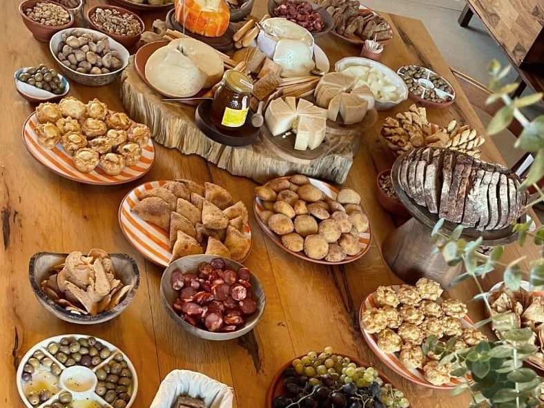Long table spread with cheese, bread and olives