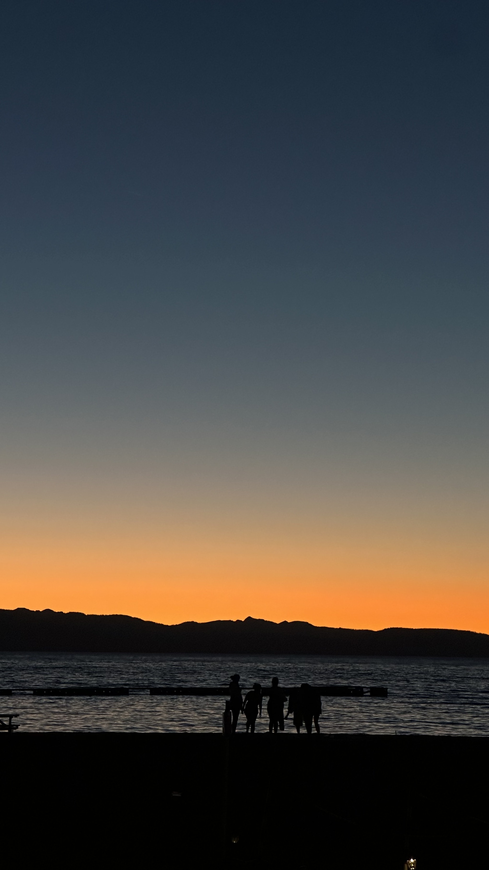 Friends on the beach at Lake Tahoe at dusk